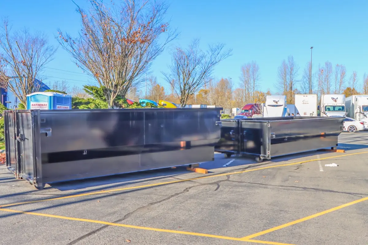 Professional dumpster rental service with roll-off container on residential driveway in Stanford